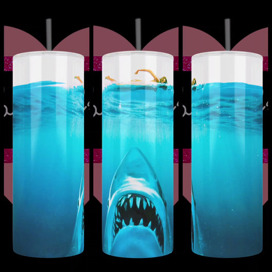 Jaws inspired design with great white shark rising from the depth of the ocean and skinny-dipping woman swimming above, handcrafted on a stainless steel tumbler