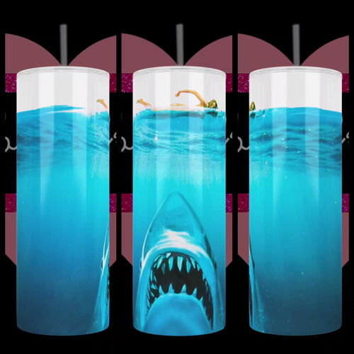 Jaws inspired design with great white shark rising from the depth of the ocean and skinny-dipping woman swimming above, handcrafted on a stainless steel tumbler